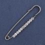Broche-épingle à strass blancs 60×12 mm ± métal argenté