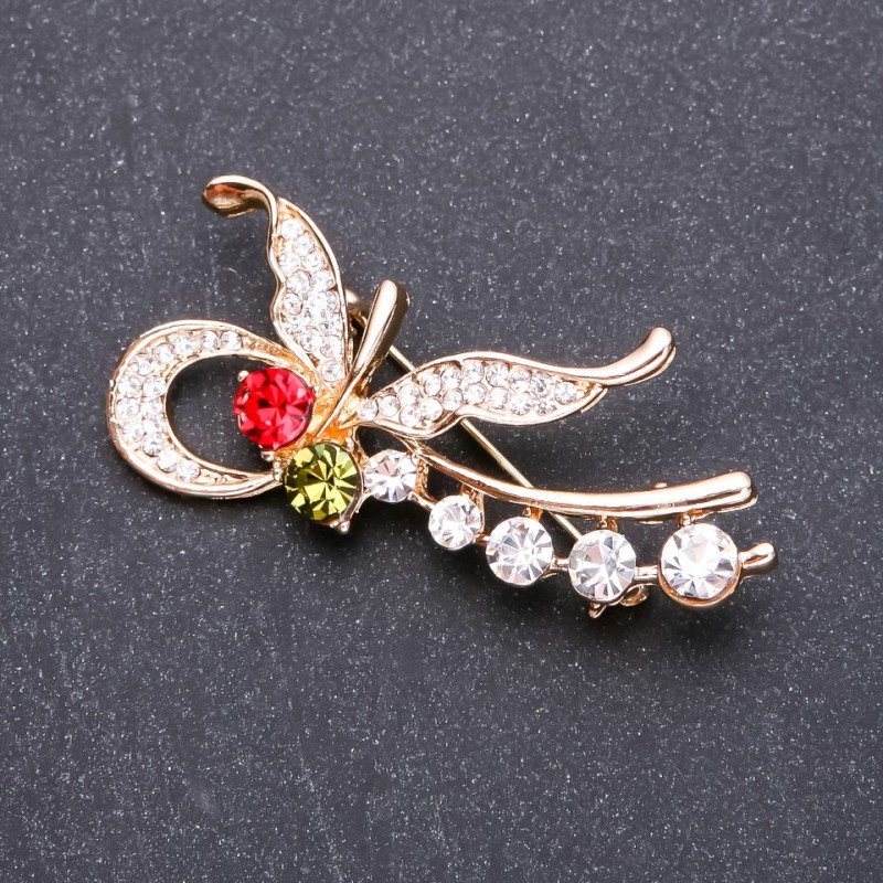 Broche papillon à strass multicolores 55×25 mm métal jaune